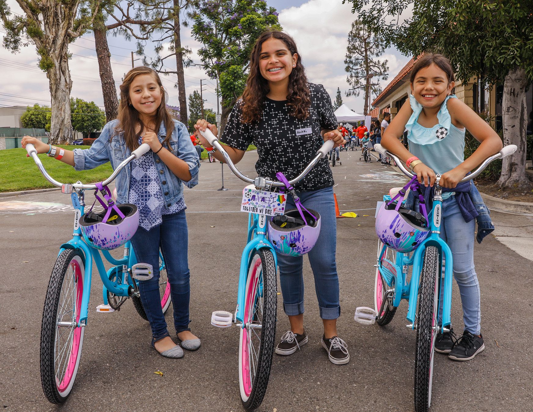 Three girls riding bycicles